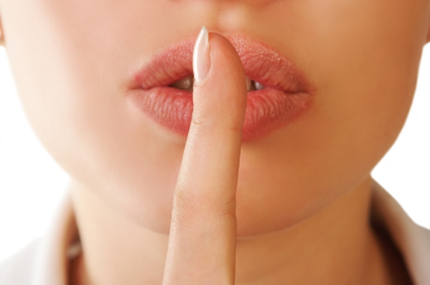 Woman with Finger to Lips